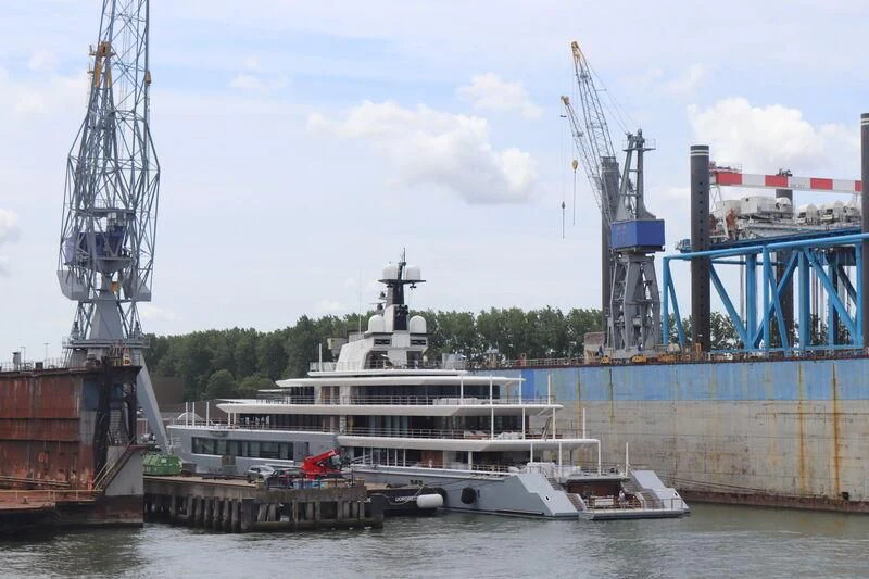 a large boat docked at a port aboard SEVEN SEAS Yacht for Sale