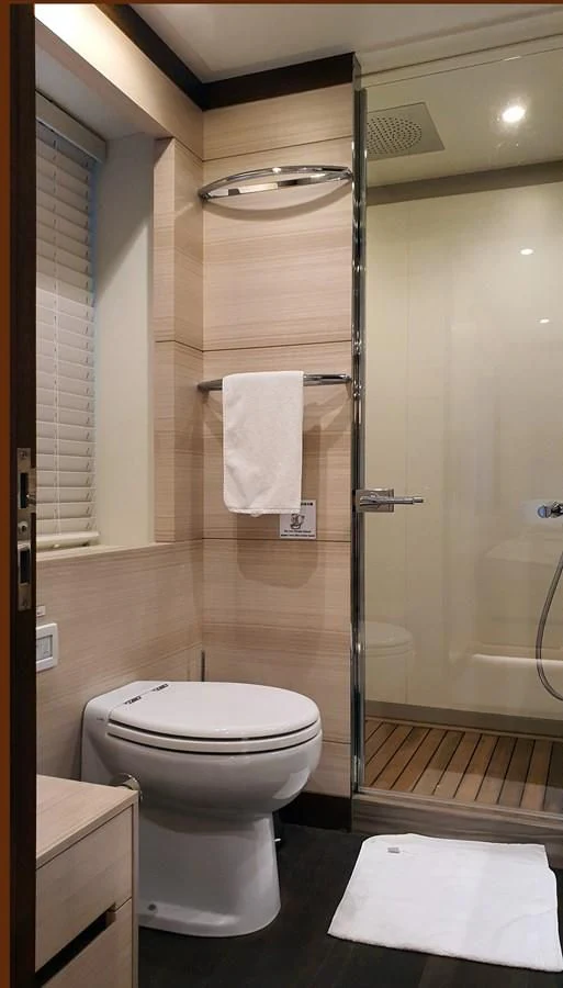 a bathroom with a glass shower door aboard CALYPSO Yacht for Charter