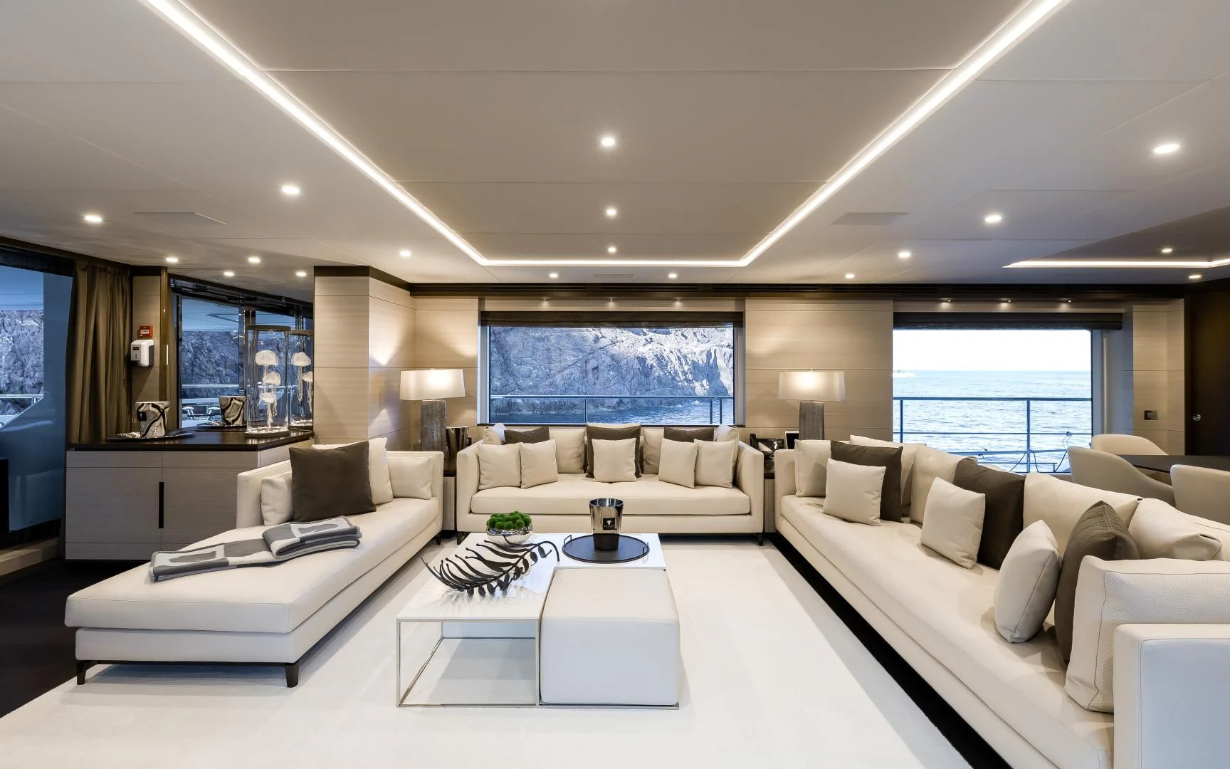 a large living room with white furniture aboard CALYPSO Yacht for Charter