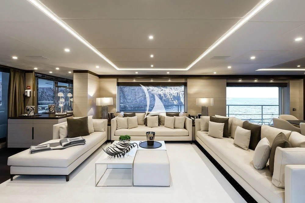 a large living room with white furniture aboard CALYPSO Yacht for Charter