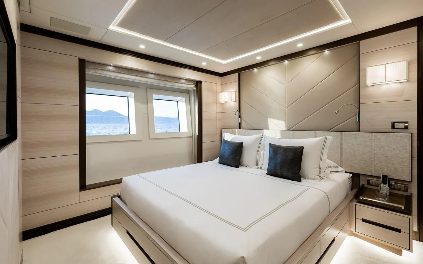a large white bed in a room aboard CALYPSO Yacht for Charter