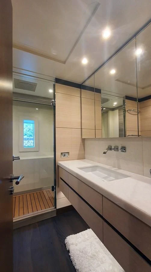 a bathroom with a large mirror aboard CALYPSO Yacht for Charter