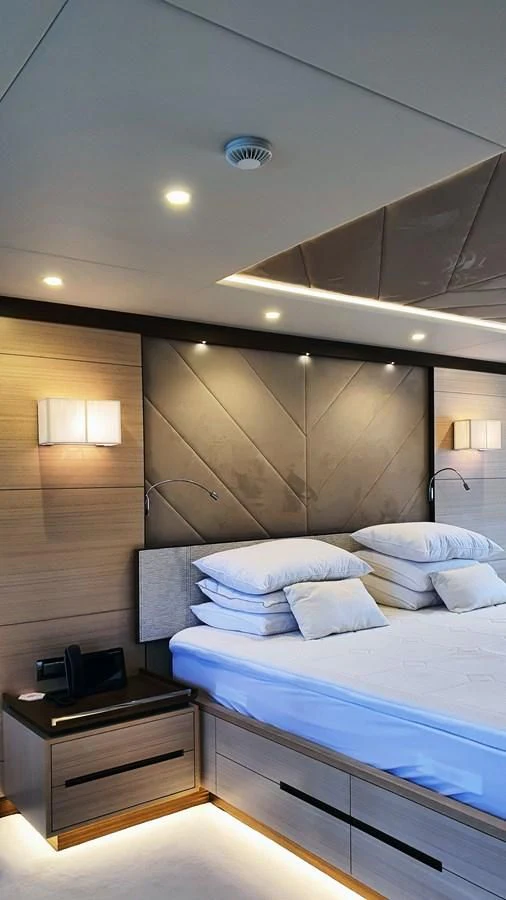 a room with a bed and a desk aboard CALYPSO Yacht for Charter