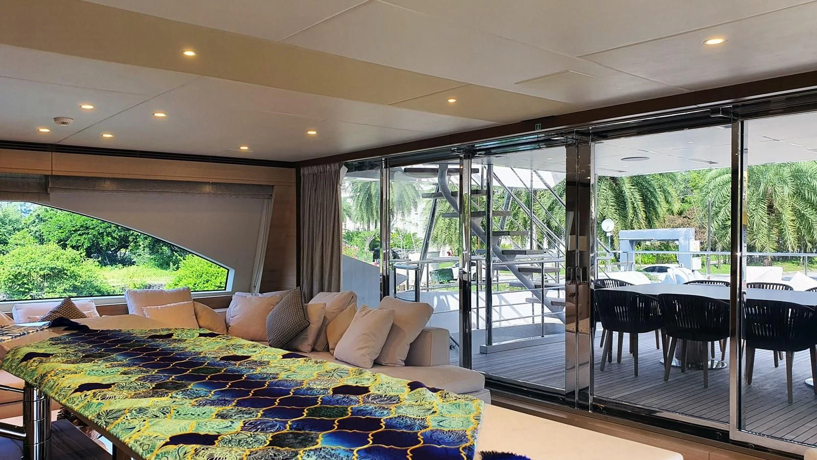 a room with a couch and a table and a large window aboard CALYPSO Yacht for Charter