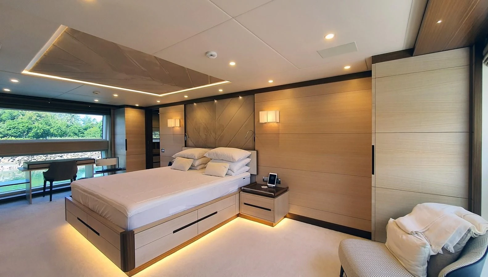 a room with a bed and a table aboard CALYPSO Yacht for Charter