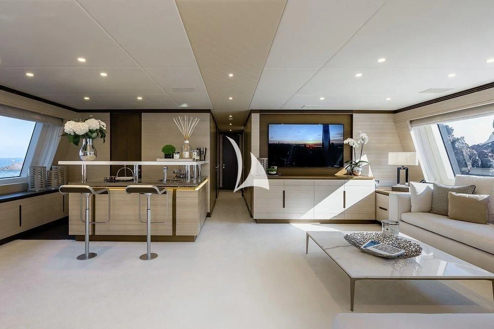 a living room with a large television aboard CALYPSO Yacht for Charter