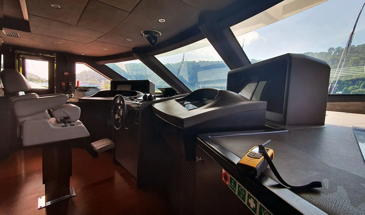 a room with a piano and a large window aboard CALYPSO Yacht for Charter