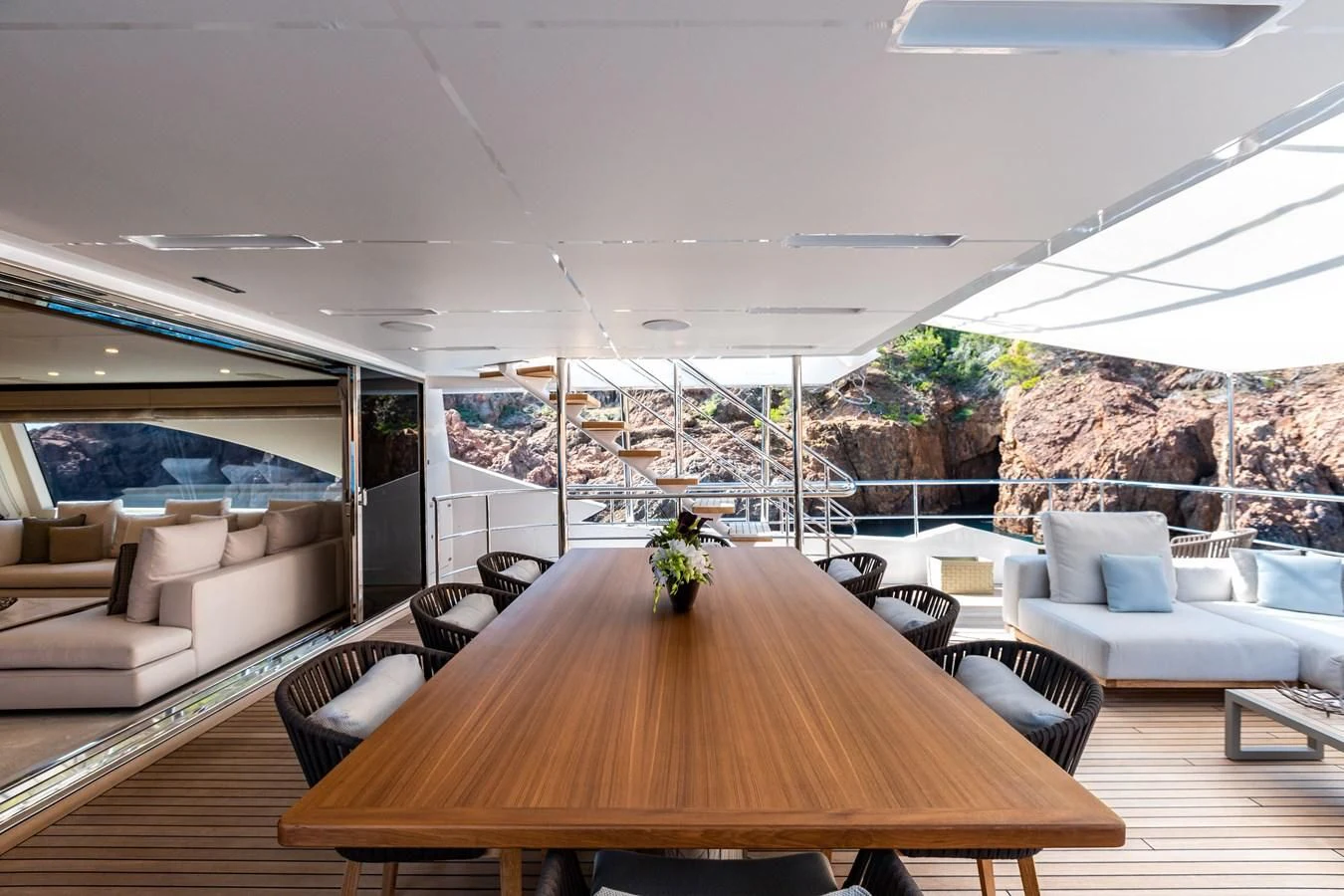 a large living room with a large table and chairs aboard CALYPSO Yacht for Charter