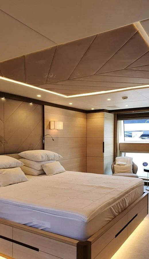 a bed with white sheets aboard CALYPSO Yacht for Charter