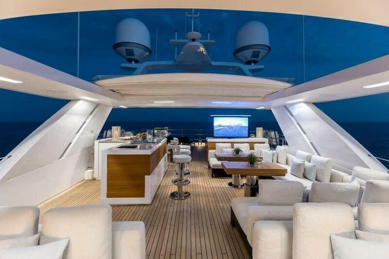 inside of a room with a large window and a wood table and chairs aboard CALYPSO Yacht for Charter