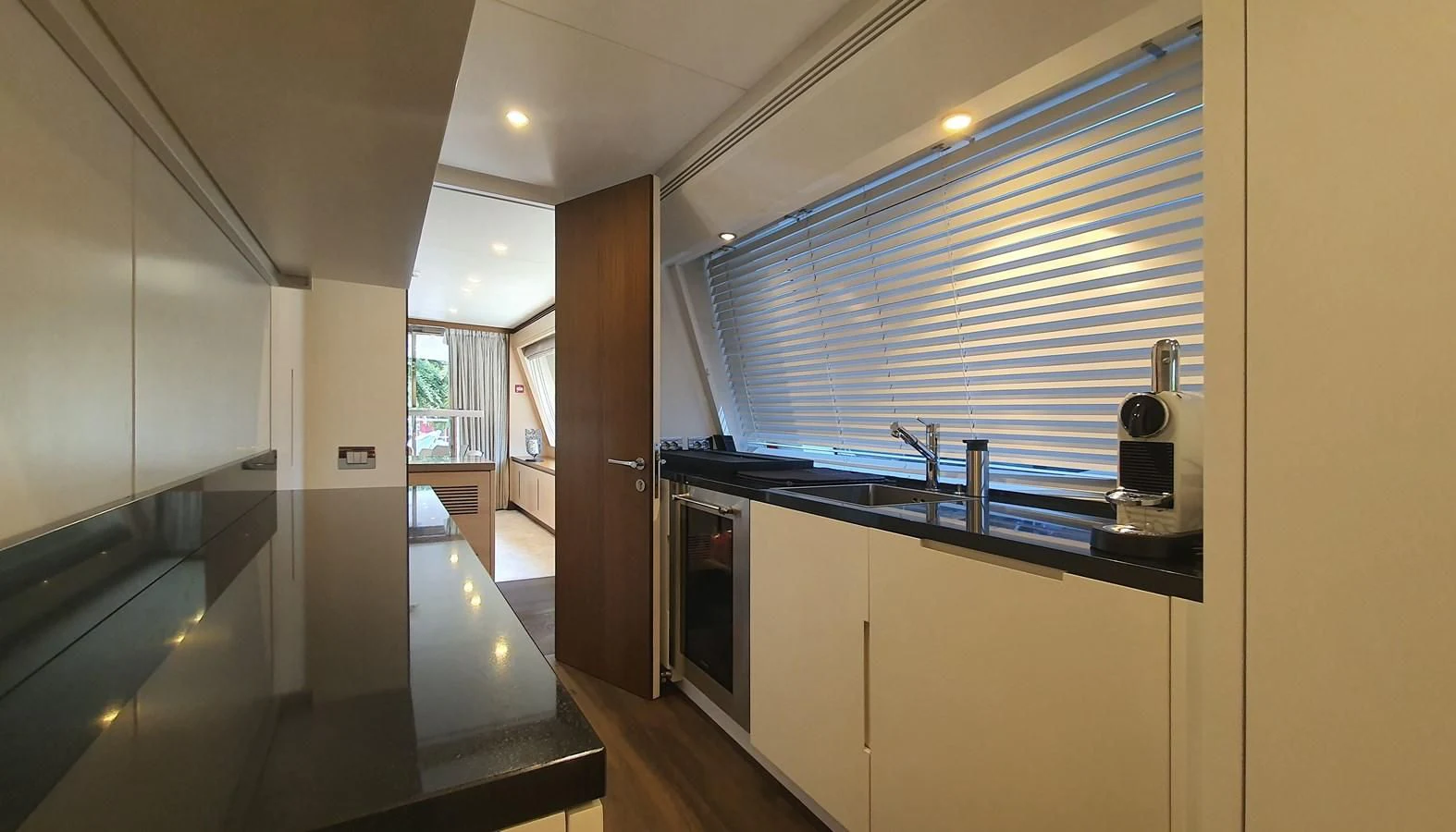 a kitchen with a large window aboard CALYPSO Yacht for Charter