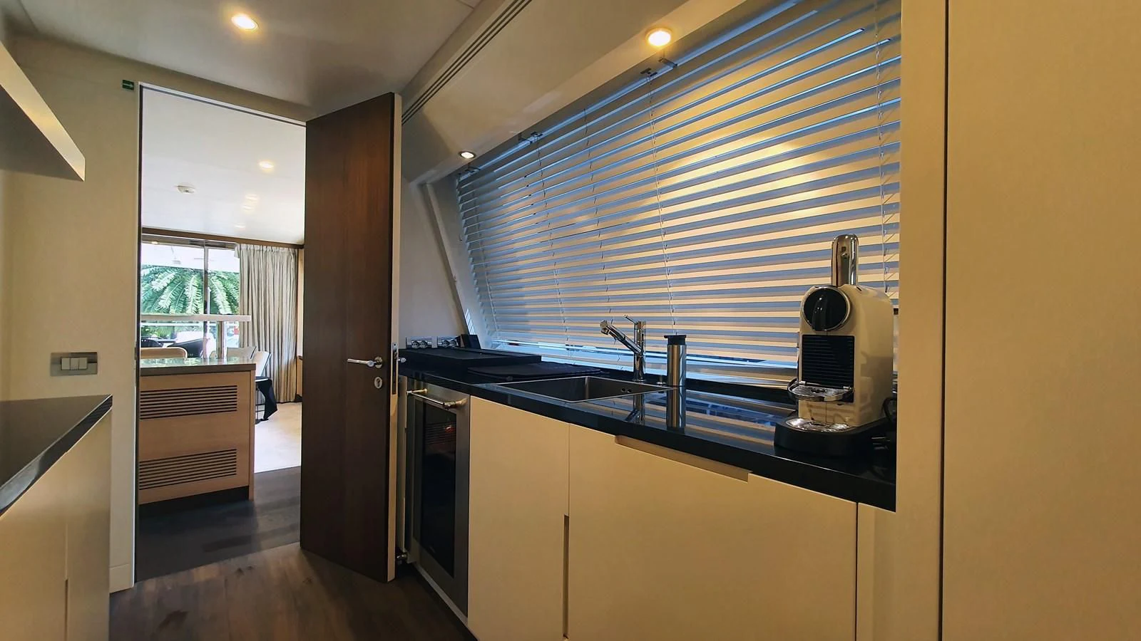 a kitchen with a sink and a window aboard CALYPSO Yacht for Charter