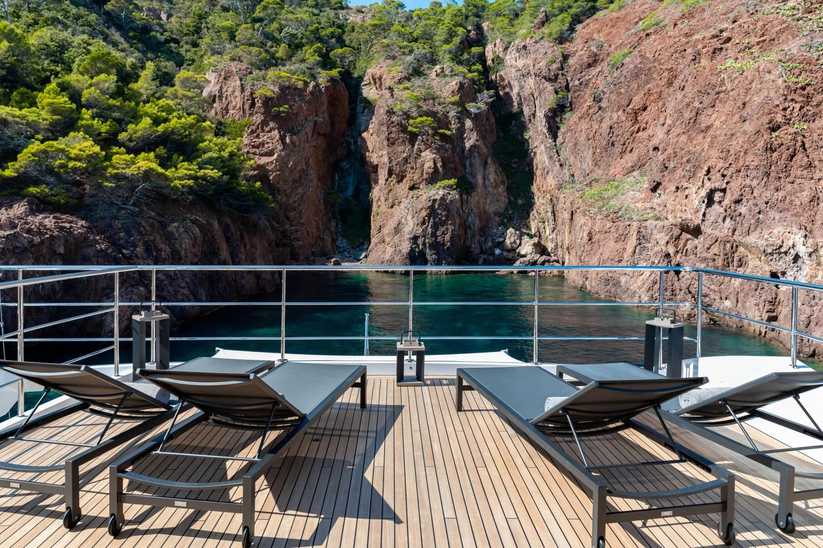 a deck with chairs on it by a body of water aboard CALYPSO Yacht for Charter