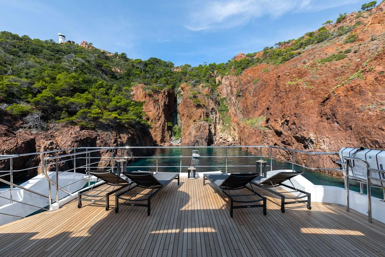 a deck with a view of a mountain and water aboard CALYPSO Yacht for Charter