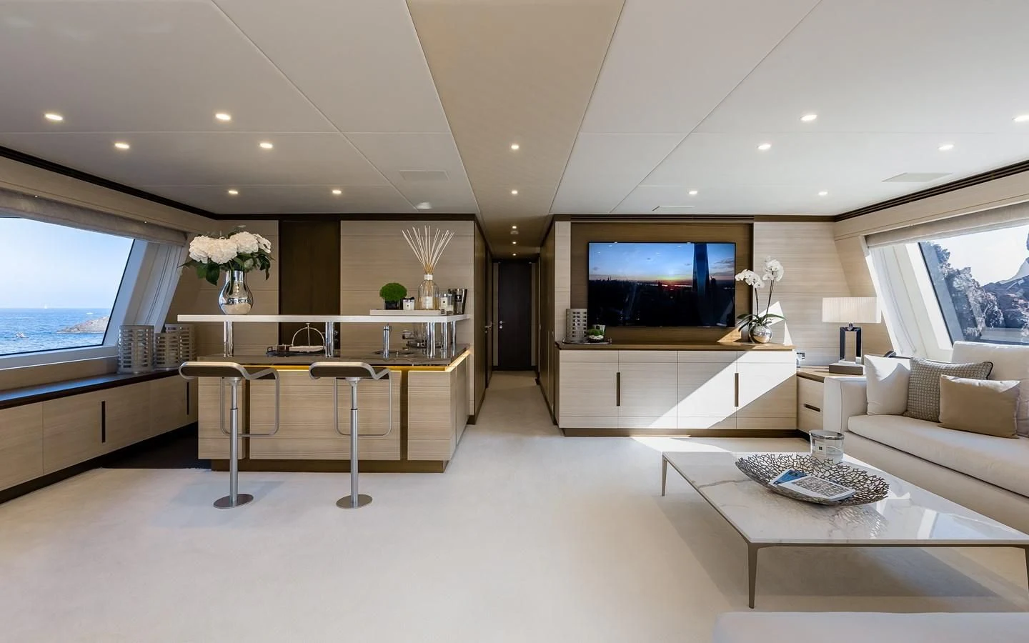 a living room with a large tv aboard CALYPSO Yacht for Charter