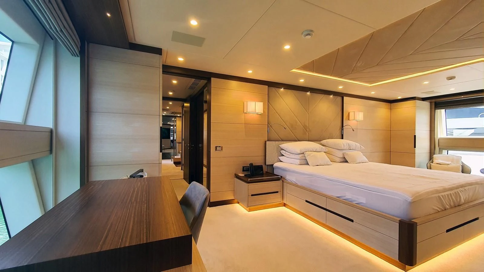 a room with a bed and a desk aboard CALYPSO Yacht for Charter