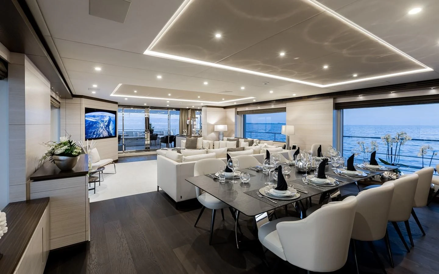 a large room with tables and chairs aboard CALYPSO Yacht for Charter