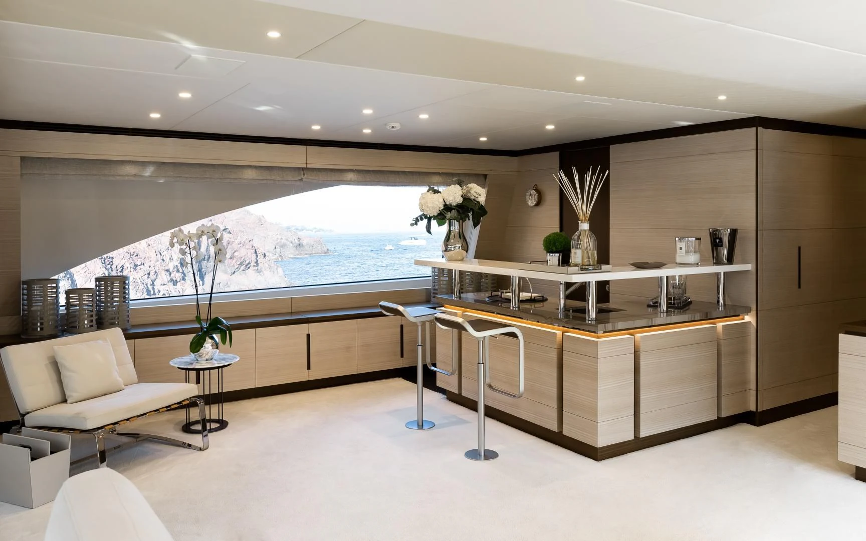 a room with a large window and a table with chairs and a large window aboard CALYPSO Yacht for Charter