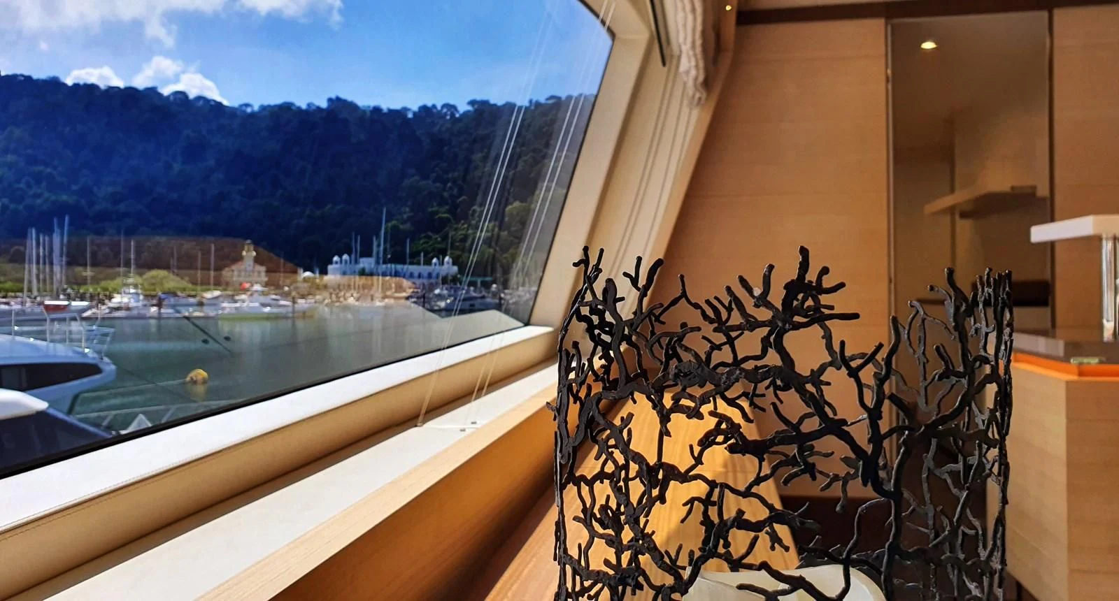 a window with a view of a city and a body of water aboard CALYPSO Yacht for Charter