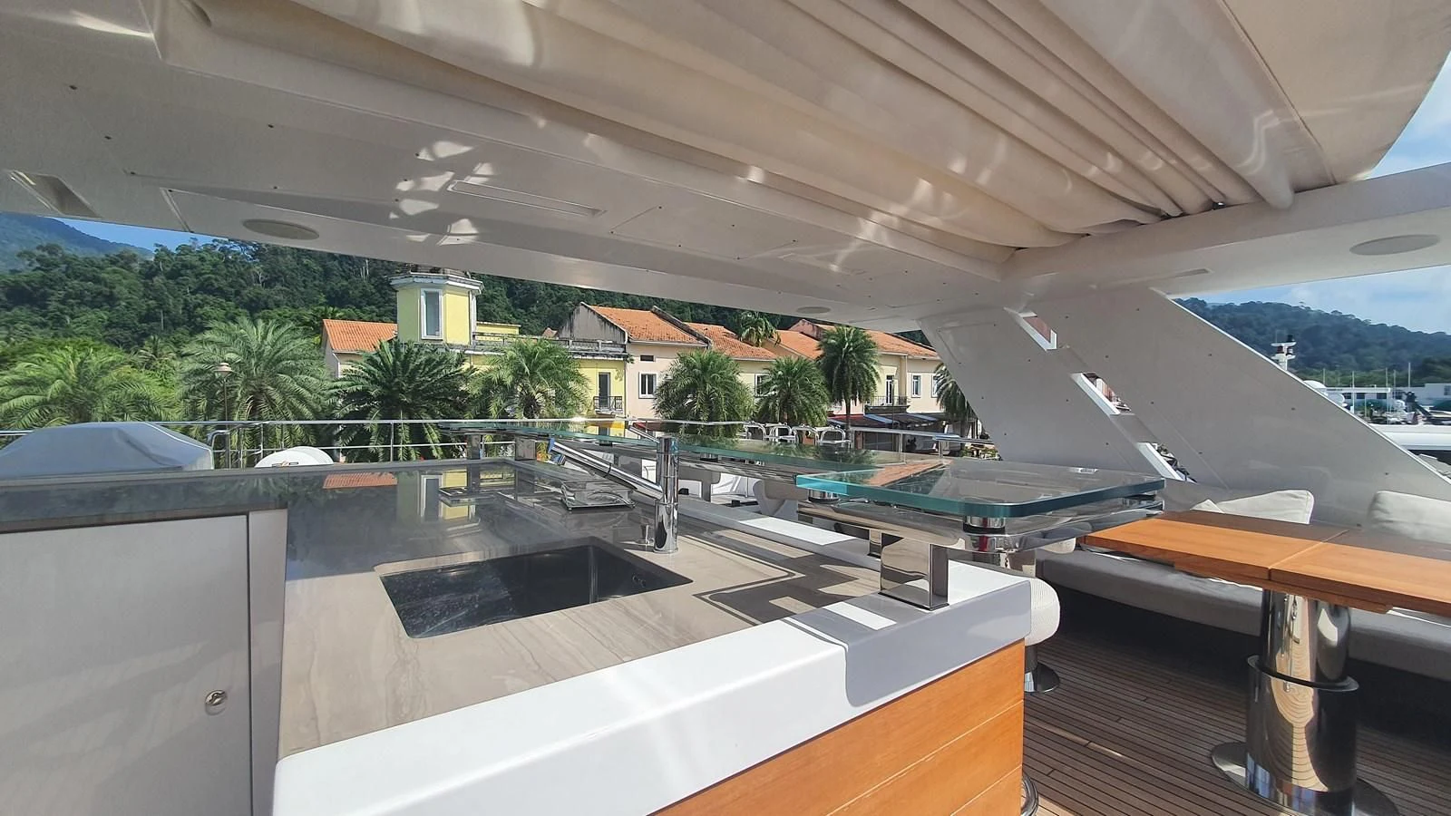 a room with a pool and a deck and trees aboard CALYPSO Yacht for Charter