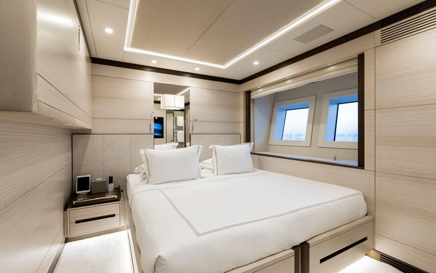a room with a bed and a window aboard CALYPSO Yacht for Charter