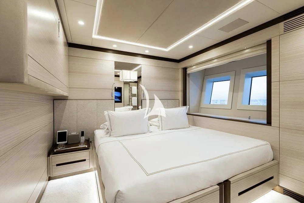 a room with a bed and a window aboard CALYPSO Yacht for Charter
