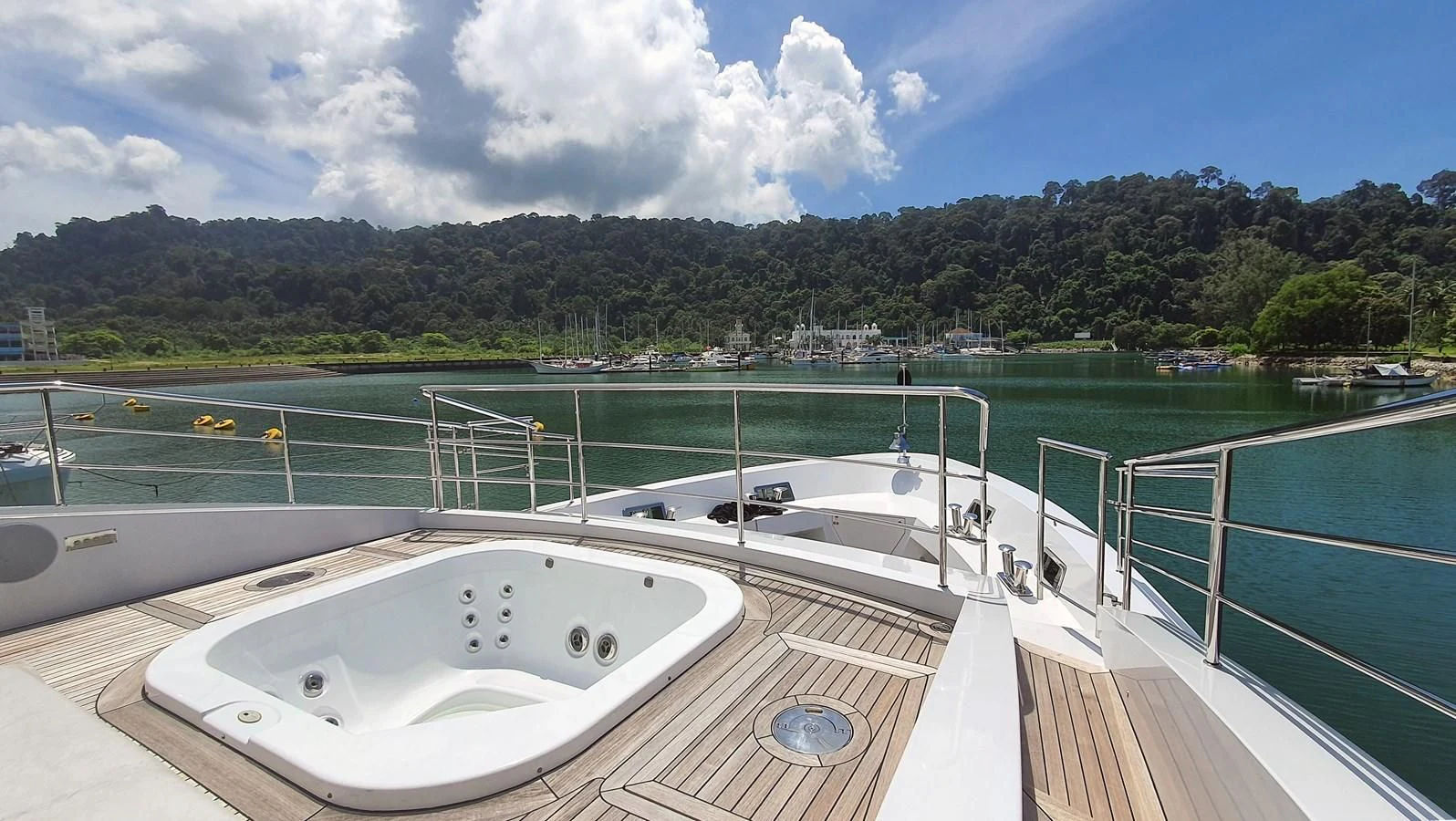 a swimming pool with a large white pool and trees in the background aboard CALYPSO Yacht for Charter