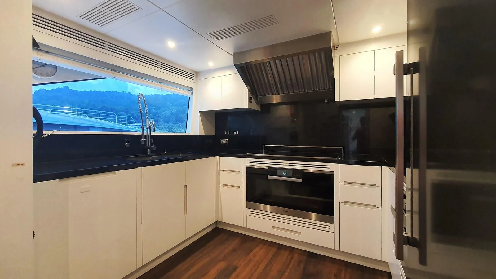 a kitchen with white cabinets aboard CALYPSO Yacht for Charter