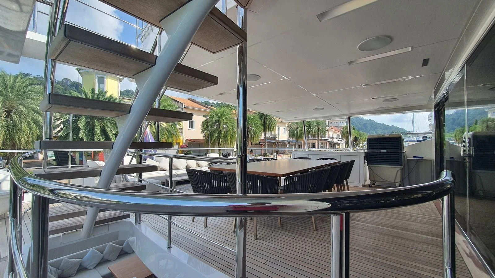 a deck with a pool and a deck with chairs and trees aboard CALYPSO Yacht for Charter