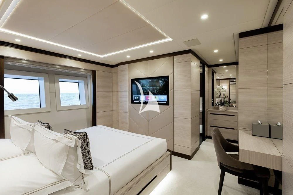 a room with a bed and a desk aboard CALYPSO Yacht for Charter