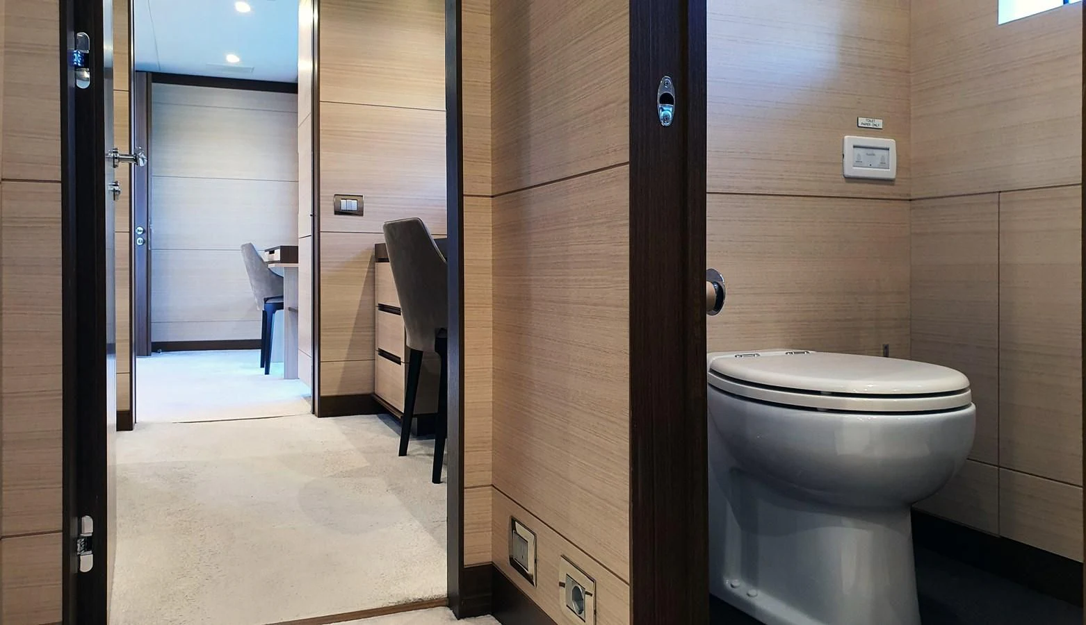 a bathroom with a toilet and a door aboard CALYPSO Yacht for Charter