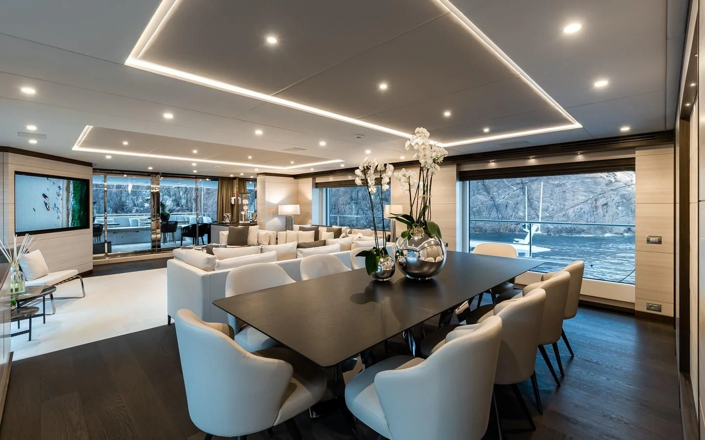 a large room with a table and chairs aboard CALYPSO Yacht for Charter