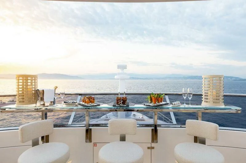 a room with a table chairs and a view of the ocean aboard CALYPSO Yacht for Charter