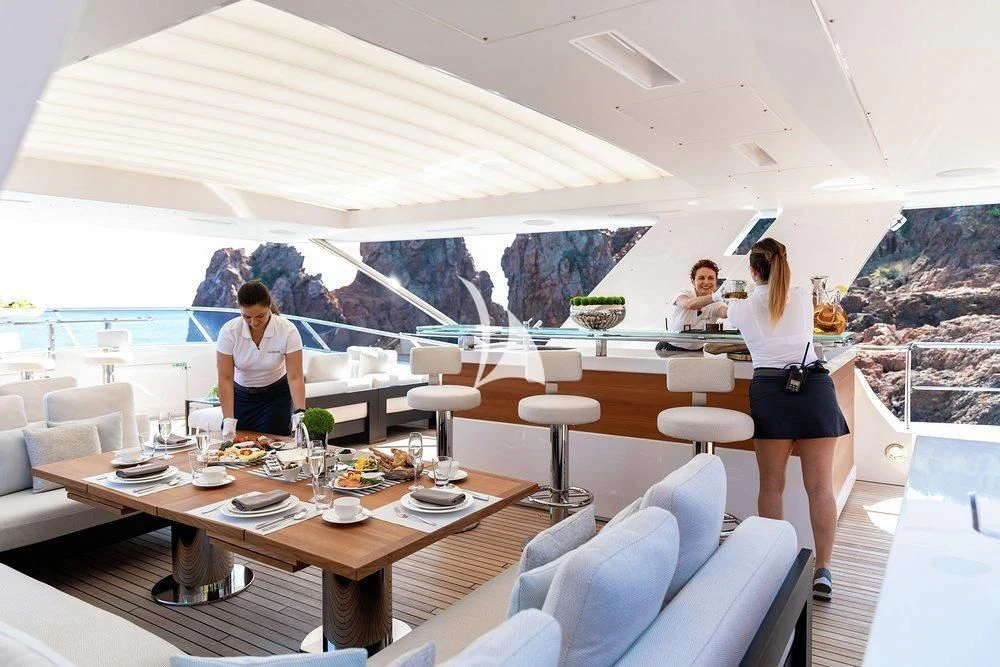 a group of people sitting around a table aboard CALYPSO Yacht for Charter