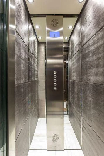 a large elevator with glass doors aboard C'EST LA VIE Yacht for Sale