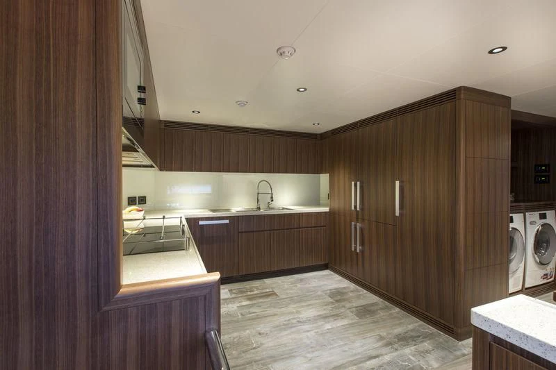 a kitchen with wooden cabinets aboard C'EST LA VIE Yacht for Sale