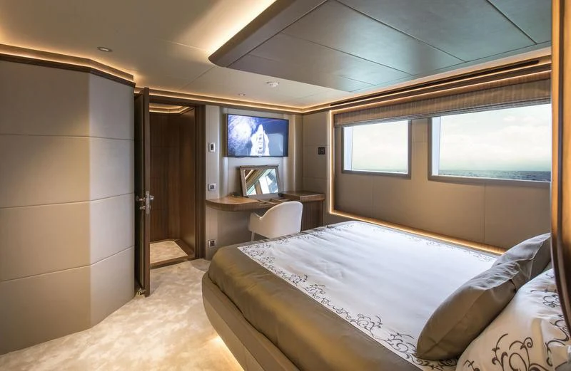 a room with a bed and a desk aboard C'EST LA VIE Yacht for Sale