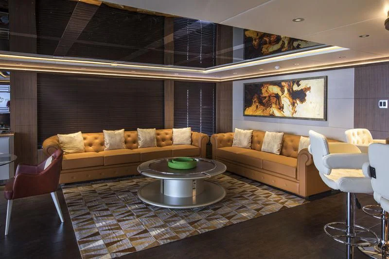 a living room with a couch and a table aboard C'EST LA VIE Yacht for Sale