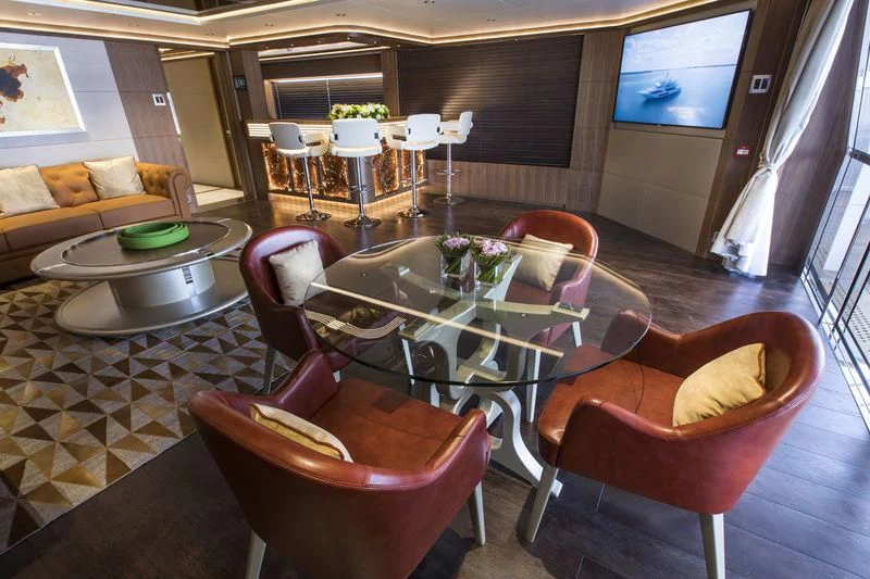 a living room with a table and chairs aboard C'EST LA VIE Yacht for Sale