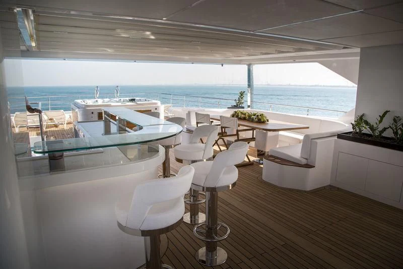 a room with a table chairs and a large window aboard C'EST LA VIE Yacht for Sale