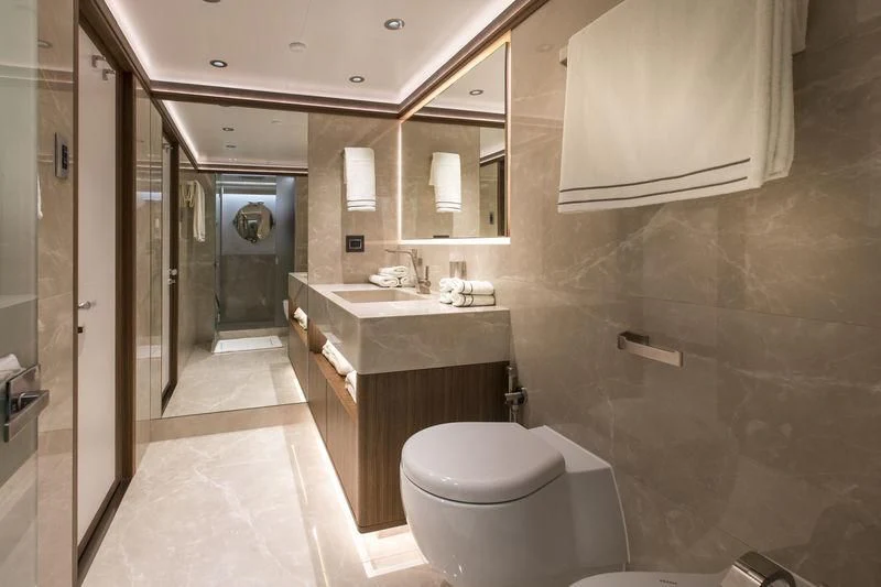 a bathroom with a toilet and a sink aboard C'EST LA VIE Yacht for Sale