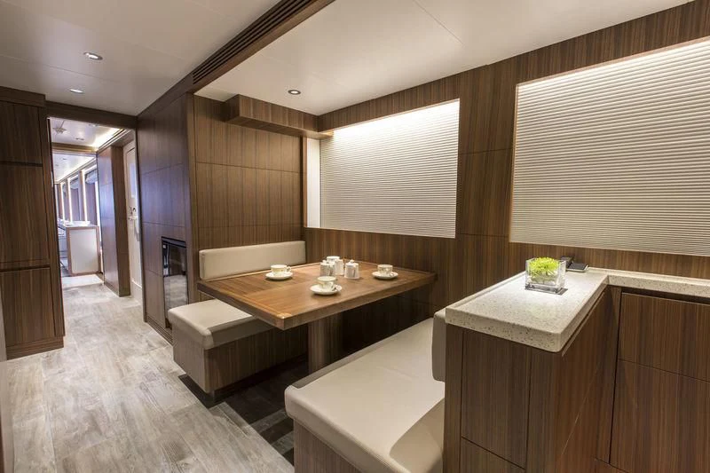 a room with a table and chairs aboard C'EST LA VIE Yacht for Sale