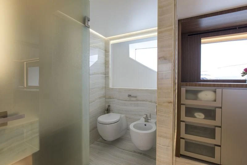 a bathroom with a toilet and a sink aboard C'EST LA VIE Yacht for Sale