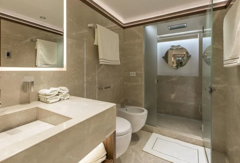a bathroom with a glass shower aboard C'EST LA VIE Yacht for Sale