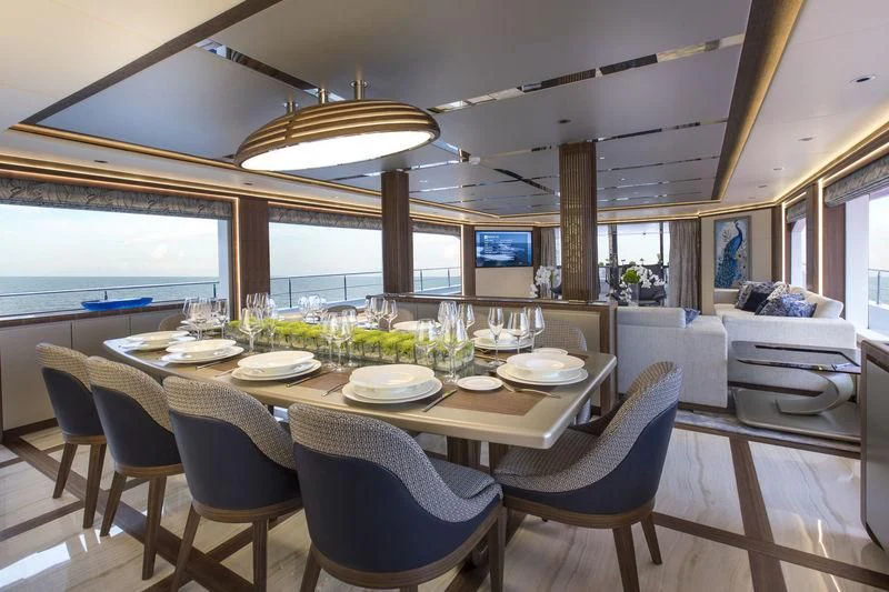 a dining room with a table set for a meal aboard C'EST LA VIE Yacht for Sale