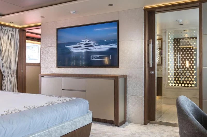a room with a tv and a bed aboard C'EST LA VIE Yacht for Sale