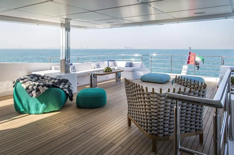 a deck with chairs and tables aboard C'EST LA VIE Yacht for Sale