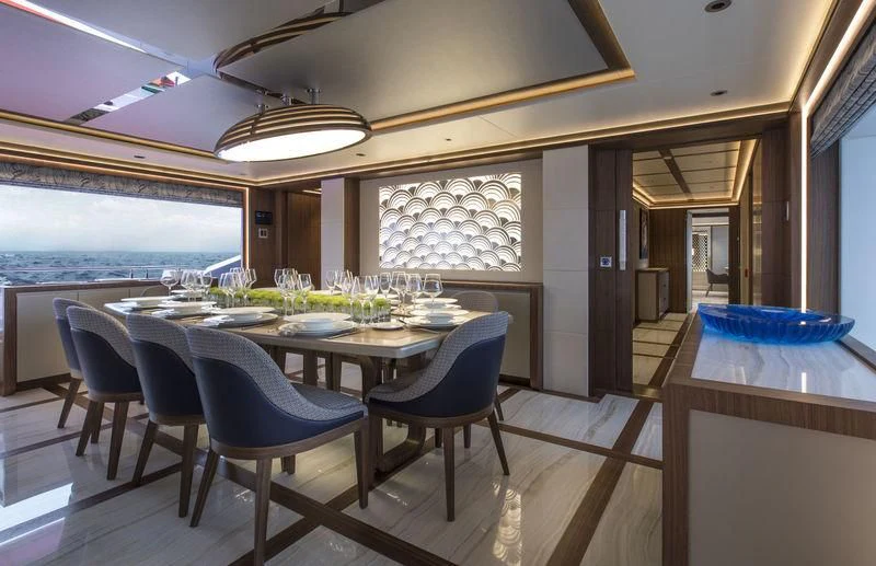 a dining room with a table and chairs aboard C'EST LA VIE Yacht for Sale