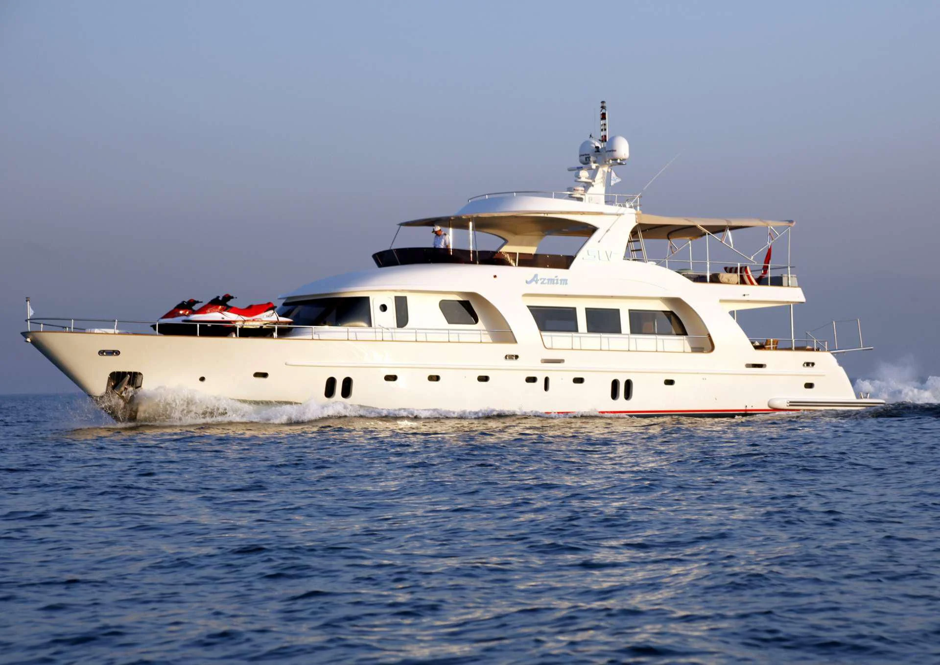a white boat in the water aboard AZMIM Yacht for Sale
