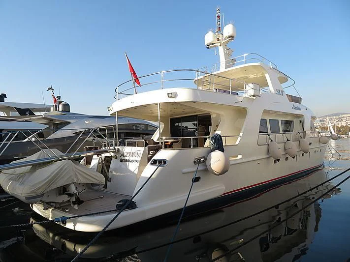 a boat docked at a pier aboard AZMIM Yacht for Sale